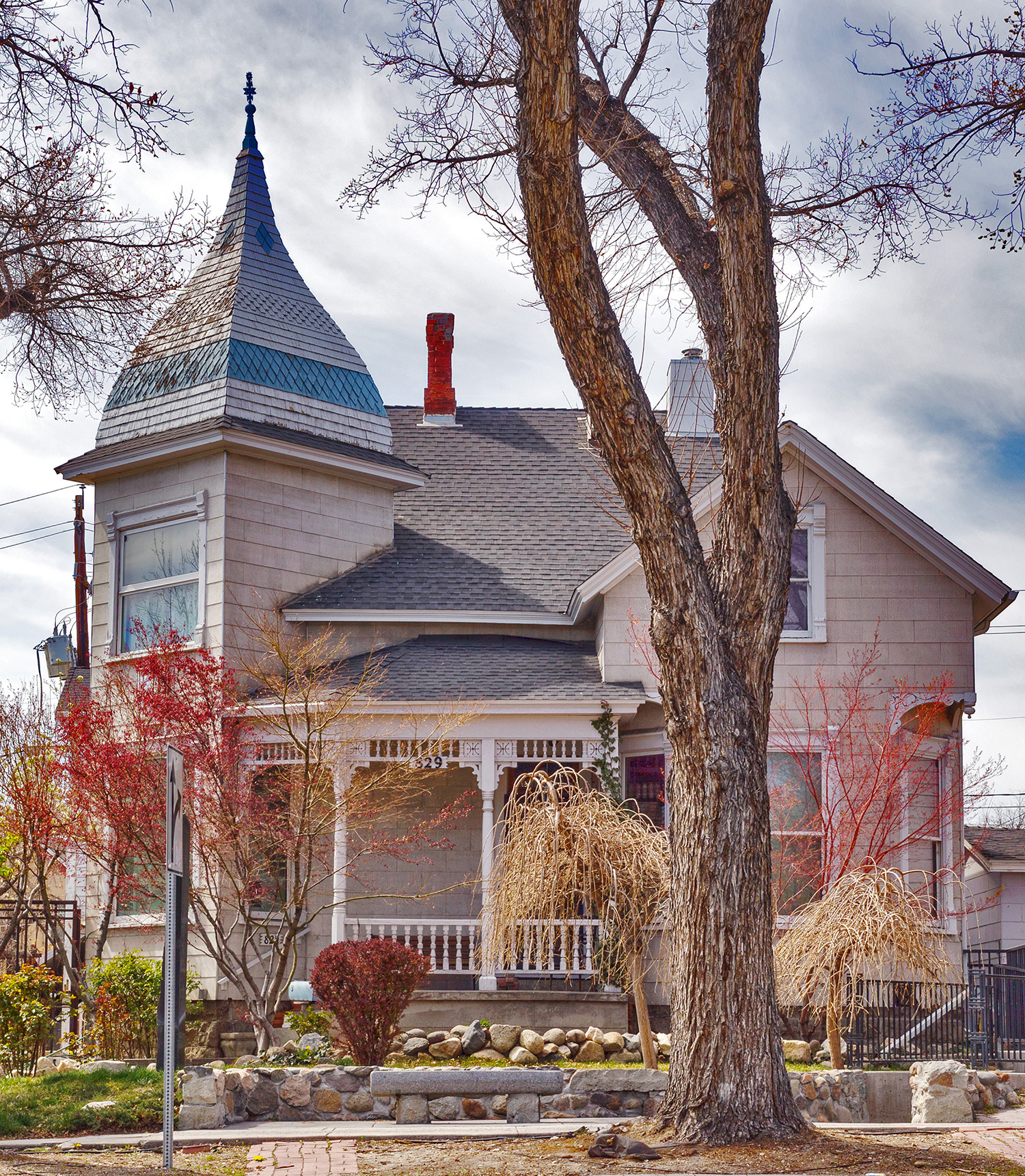 Current view of the home with fall colors and a patchy sky.